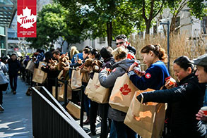Tim Hortons® Shanghai lineup of people looking at gift bags with swag
